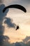 Silhouette paraglider on sunset sky