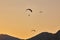 Silhouette Of Paragliders Against Dramatic Sky