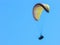 Silhouette of paragliding tandem floating in the air against clear blue sky. active lifestyle and extreme sport adventure concept