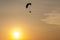 Silhouette of Paramotors flying to sky on sunset Adventure man active extreme sport pilot flying in sky with paramotor engine glid