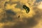 Silhouette of Parasailing at the beach with cloudy background