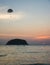 Silhouette of Parasailing at Kata beach with sunset background, extreme sports