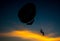 Silhouette of Parasailing at Kata beach with sunset background, extreme sports, Thailand