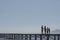 Silhouette Parents And Kids Holding Hands On Jetty