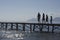 Silhouette Parents And Kids Walking On Jetty