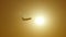 Silhouette of passenger airplane flies across sun at sunset. Plane taking off at sunrise background. Aircraft crossing