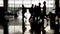 Silhouette of passenger walk with trolley case at airport terminal