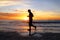 Silhouette of Peaceful Man Running Alone on Beach at Sunset