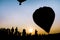 Silhouette people in the Balloon festival on beautiful sunset sky at Singha Park, Chiang Rai, Thailand