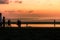 Silhouette of people on a beach at sunset after the sun has set below the horizon at Seminyak Beach, Bali, Indonesia, Asia