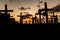 Silhouette of people and crosses fixed on the ground in honor of those killed by covid-19