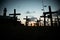 Silhouette of people and crosses fixed on the ground in honor of those killed by covid-19