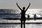 Silhouette of People playing, swimming in the waves in the island of Patmos, Greece in summer time