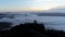 Silhouette people standing on top of the mountain watching the sun rise with fog.