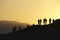 Silhouette of people viewing sunset from a viewpoint above Moon Valley, Atacama Desert, Chile