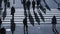 Silhouette people walk on pedestrian crosswalk at the junction