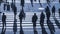 Silhouette people walk on pedestrian crosswalk at the junction s