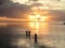 Silhouette of people walking in the water in Tahiti. french Polynesia