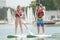 Silhouette perfect couple engage standup paddle boarding