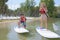 Silhouette perfect couple engage standup paddle boarding