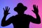 Silhouette of perplexed young african american man his hands up guy on blue and pink neon background studio portrait