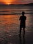 Silhouette of a person observing calm positive Sunset over sea in Thailand, Ao Nang beach, Krabi province