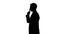 Silhouette of person showing gesture of silence, censorship, confidential data