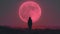 Silhouette of a person standing under a giant pink moon at night