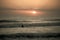 Silhouette of a person surfing on the background of the mesmerizing sunrise