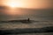 Silhouette of a person surfing on the background of the mesmerizing sunrise