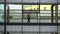 Silhouette Of A Person Walking Inside A Building. Exterior of modern office building and man in silhouette walking past