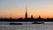 Silhouette of Peter and Paul fortress against the backdrop of the setting sun