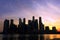 The silhouette photo of a group of buildings by the bay