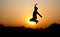 Silhouette photo of jumping young male boy during sunset