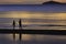 The silhouette photo of two brothers enjoy on the beach