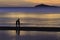 The silhouette photo of two brothers enjoy on the beach