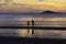 The silhouette photo of two brothers enjoy on the beach