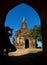 Silhouette of photographer in arch at the entrance to pagoda