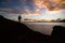 Silhouette of a photographer capturing sunrise