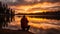 Silhouette of photographer on reflective lake at sunset