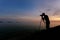 Silhouette of a photographer or traveler using a professional DSLR camera,photographer take sunset photo