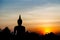 Silhouette photography of Buddha image monument in sunset sky