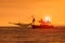 Silhouette photography of fishery boat and sunset sky over sea h