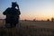 Silhouette Photos young disabled man with field background.He is wearing a hat and sitting on wheelchair