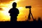 Silhouette picture of boy standing with camera