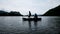 Silhouette Picture : Two fishermen are fishing on a lake fishing boat.