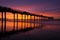 Silhouette pier at beach and brilliant sunset