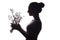 Silhouette pof a beautiful girl with a bouquet of dry dandelions, the face profile of a dreamy young woman on a white isolated