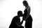 Silhouette portrait of Husband man kissing pregnant woman belly