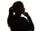 Silhouette portrait of a pensive girl with hand under chin , young woman on white isolated background thinking